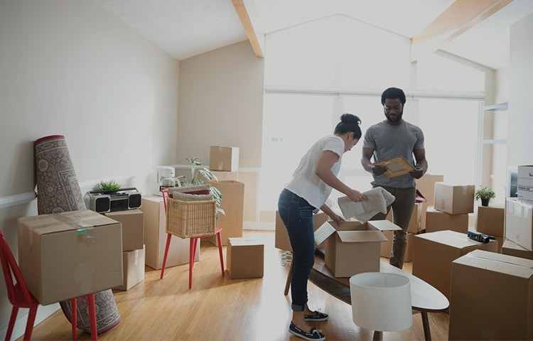 Couple packing their boxes to move