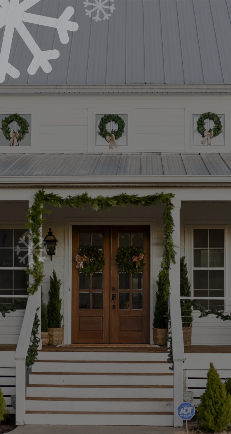 House with an ADT sign decorated with holiday decorations 