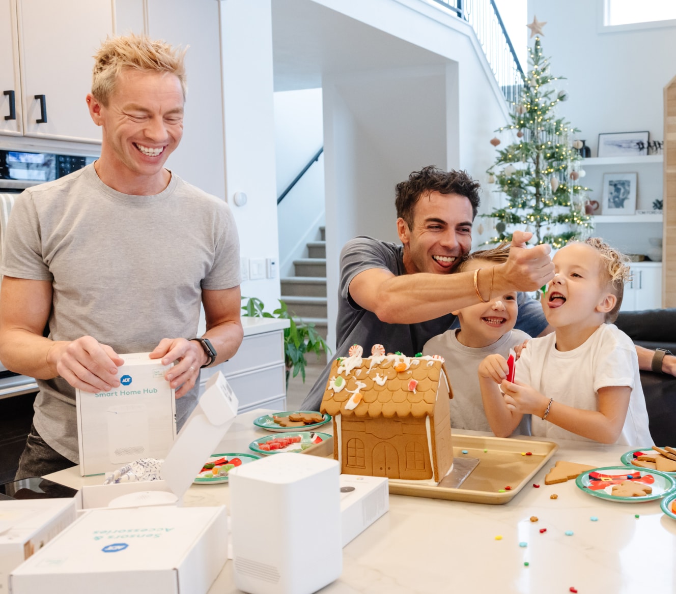 Family making a gingerbread house and opening ADT products