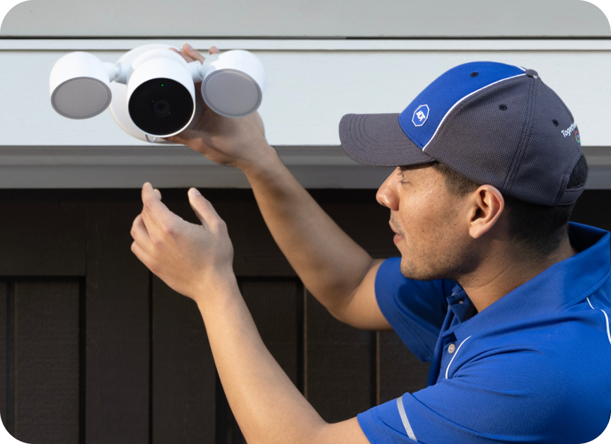 An ADT Tech Specialist installing a Google outdoor camera