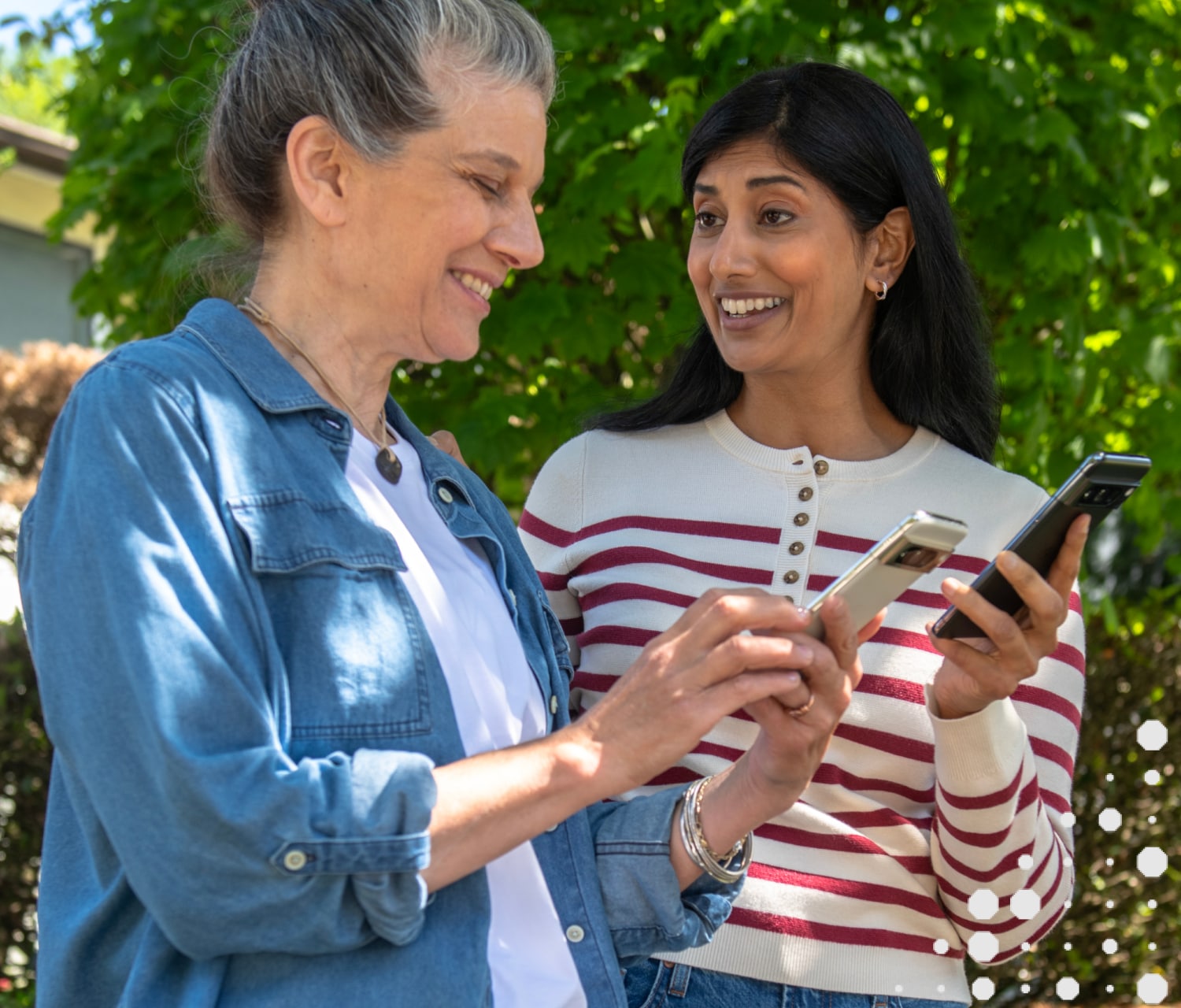 Woman showing her friend the Trusted Neighbor app on her phone 