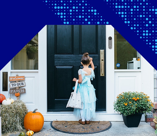 Little girl trick or treating in front of an ADT protected home