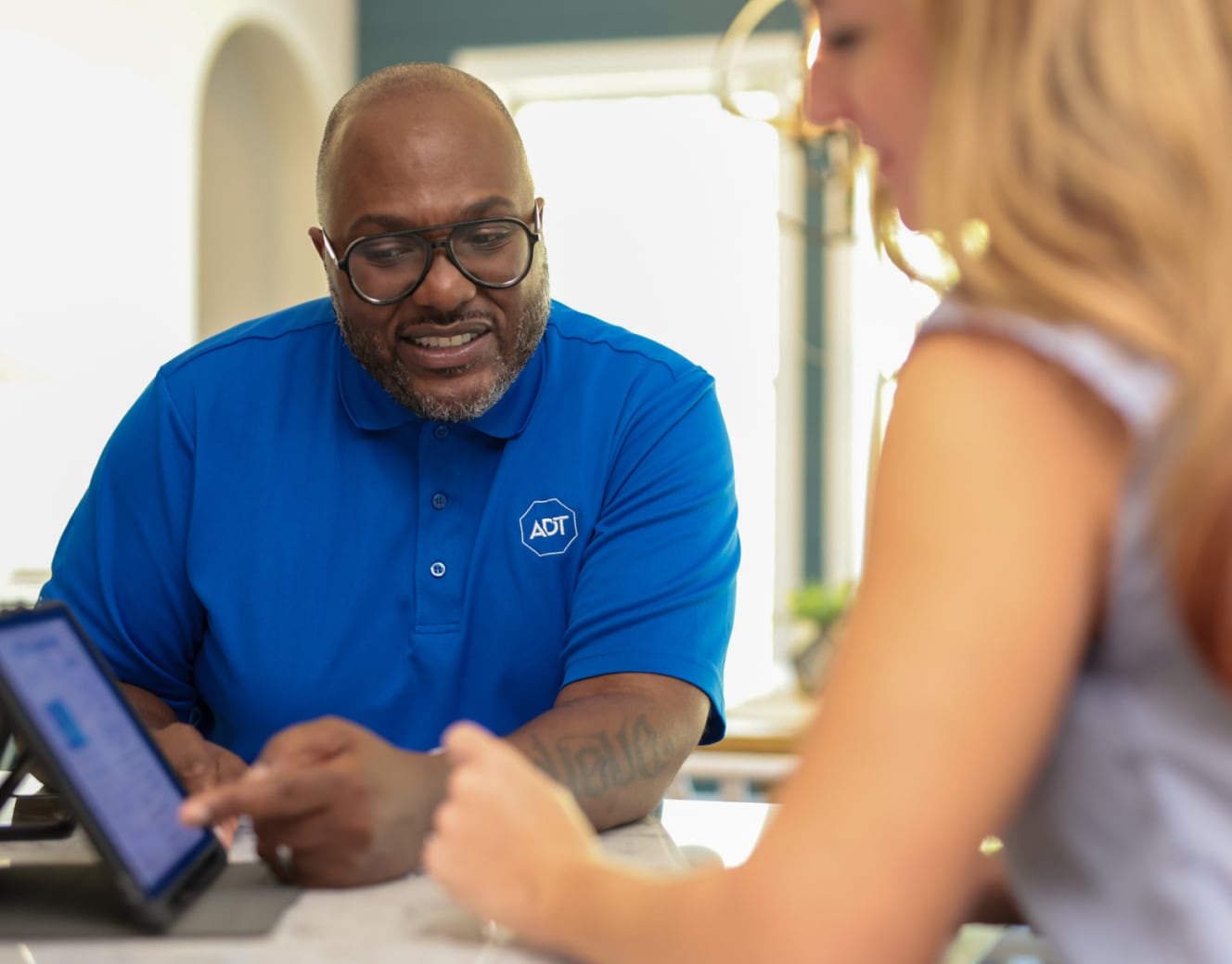 ADT installer consulting with a customer for her ADT protected home