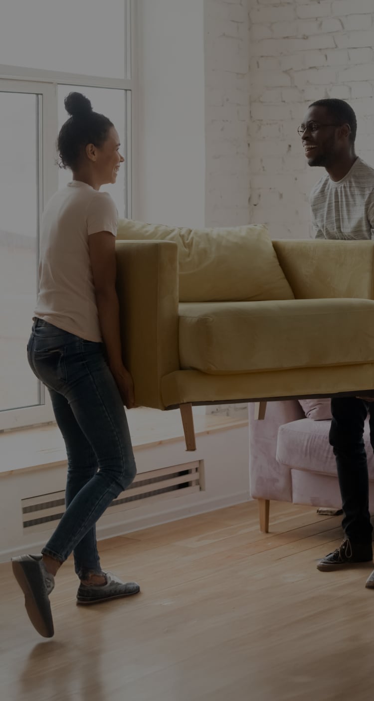 Couple moving a couch 