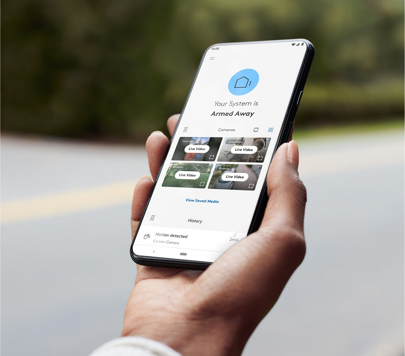 Hand holding a phone showing the ADT+ app Hand holding a phone showing the ADT+ app