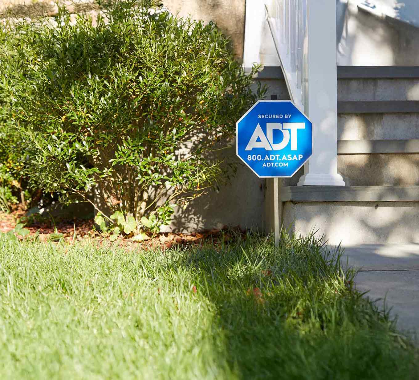 Woman adjusting an indoor camera in her home on a shelf