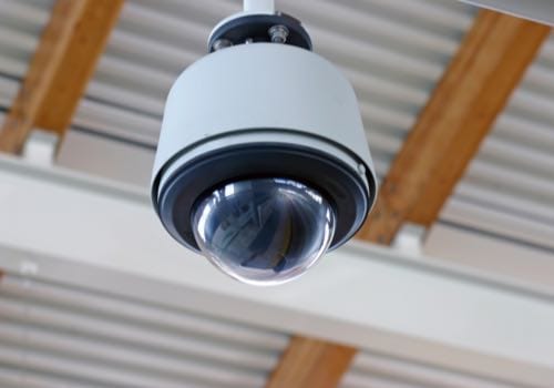 Surveillance camera in warehouse ceiling