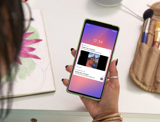 Woman using ADT+ app on cell phone Woman using ADT+ app on cell phone