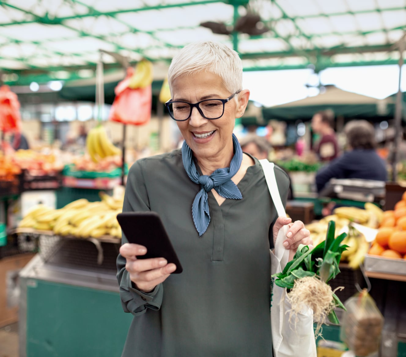 Woman using the ADT app on her phone in the grocery store