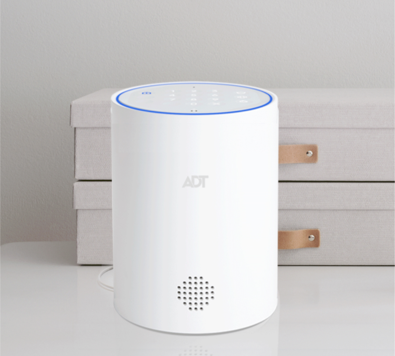 ADT Smart Home Hub on a table with drawers behind it