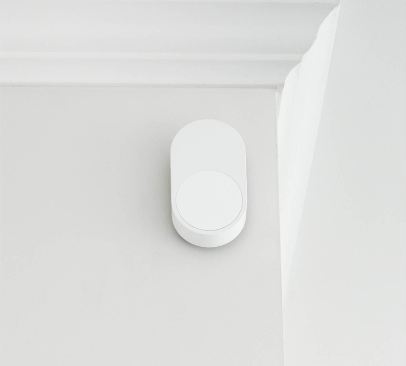 ADT Motion Sensor on a wall by a ceiling 