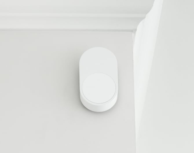 ADT Motion Sensor on a wall by a ceiling 